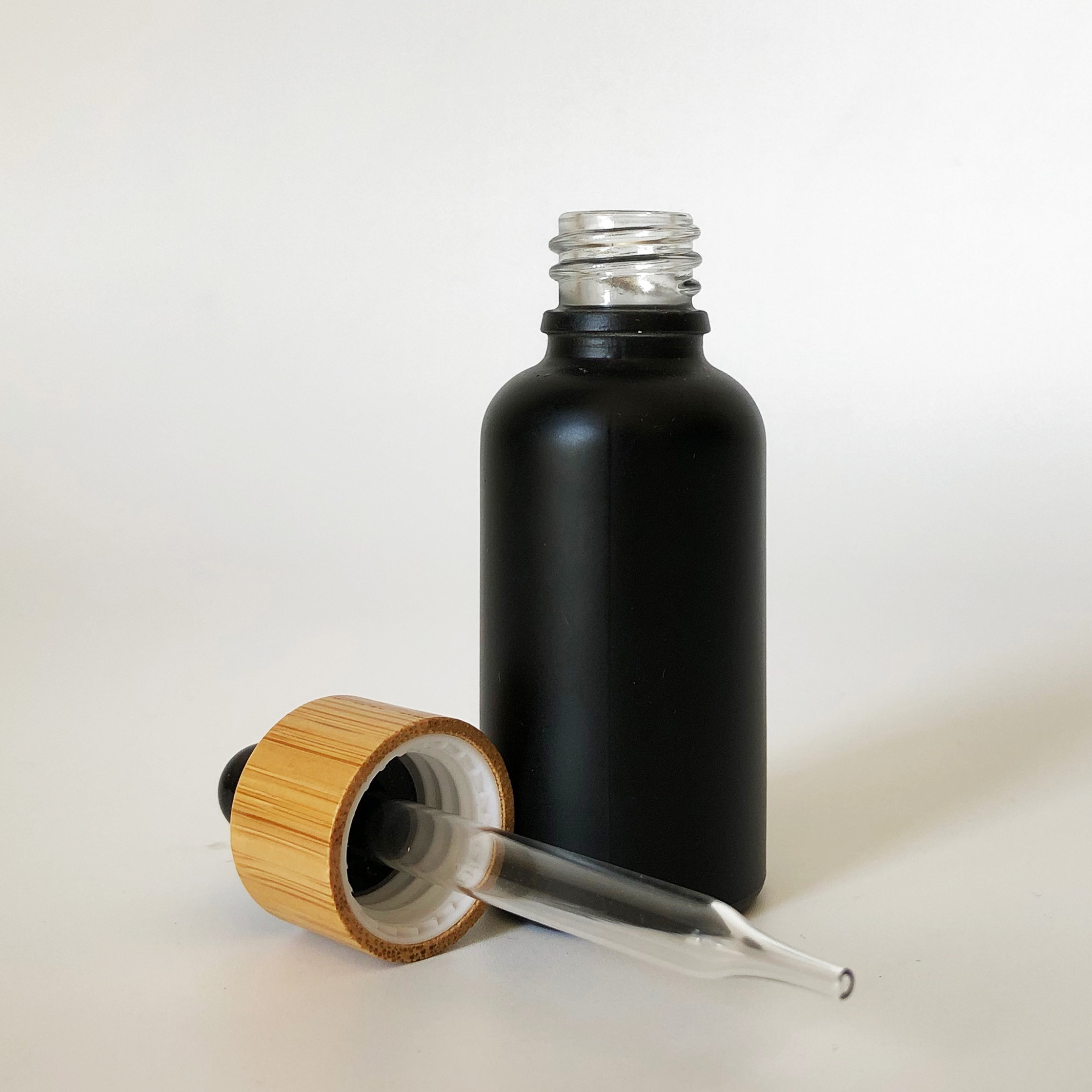 high quality 30ml black frosted glass bottle wholesale 1oz glass bottle bamboo cap