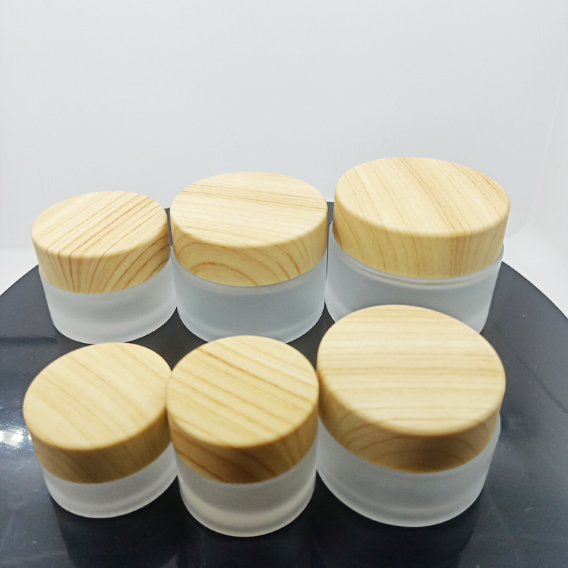 hot sale clear and frosted small glass jars for cosmetic cream with plastic cap with wood cap lid