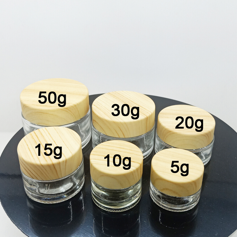 hot sale clear and frosted small glass jars for cosmetic cream with plastic cap with wood cap lid