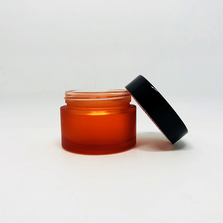hot sale cosmetic orange forested glass jar with black plastic lid custom brand and logo