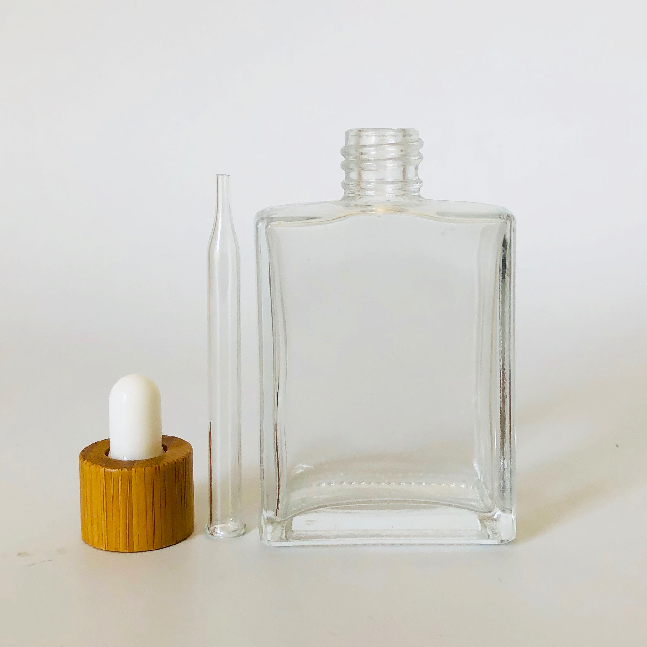 hot sale essential oil bottle 50ml rectangular clear glass dropper bottle with bamboo lid