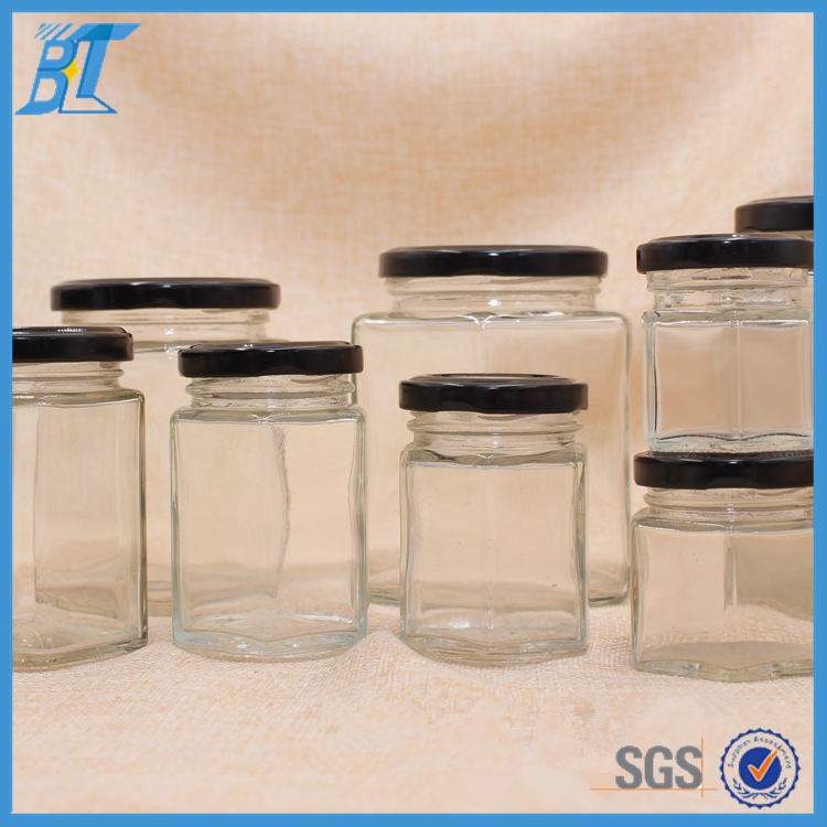 hot selling whole 700ml 35oz glass bee shaped honey jar glass hexagonal jar for honey package with screw top lid