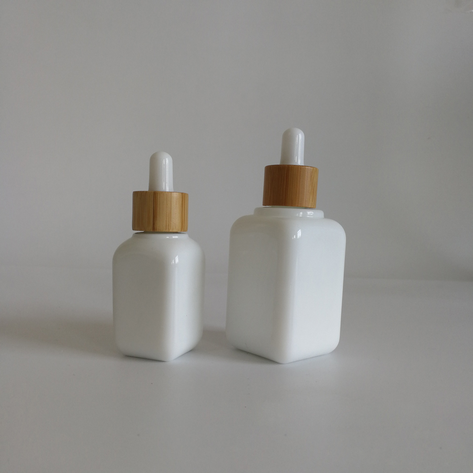luxury cosmetic packaging 30ml 50ml white glass ceramic squared CBD serums essential oils dropper bottles with bamboo rubber top