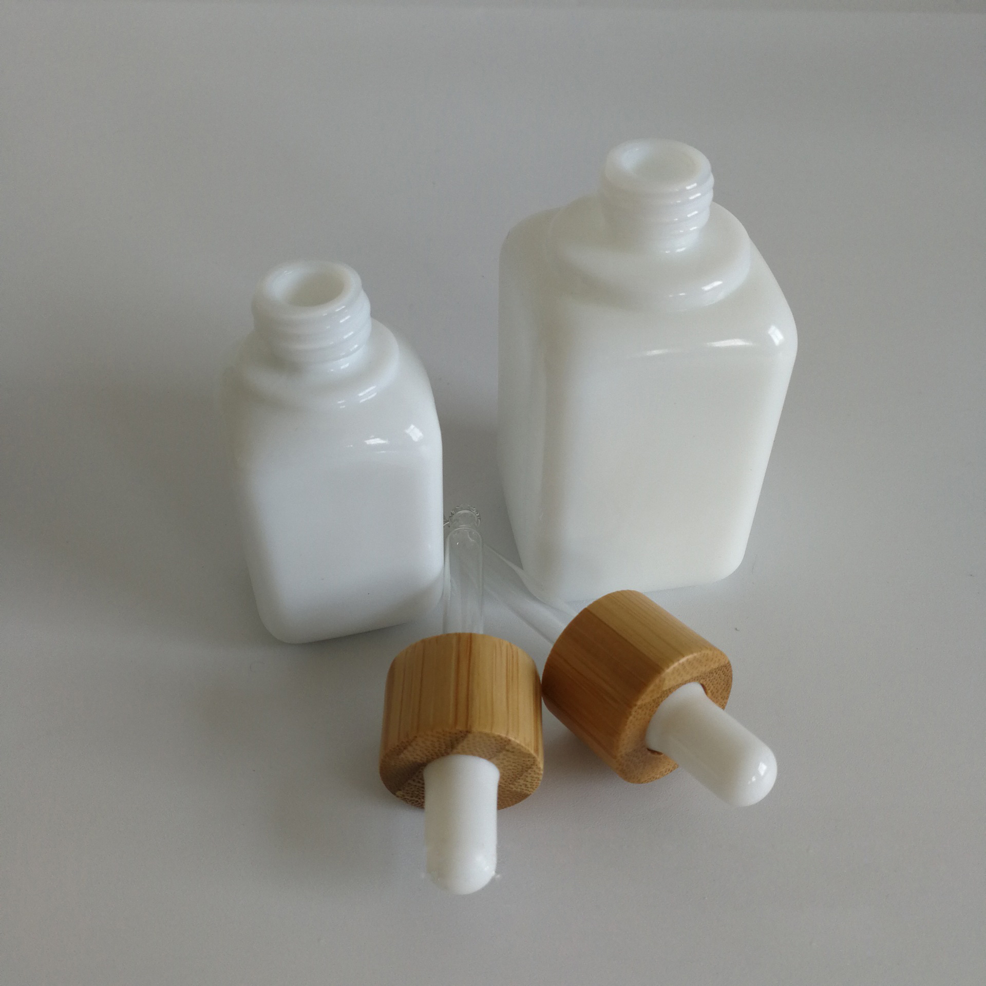 luxury cosmetic packaging 30ml 50ml white glass ceramic squared CBD serums essential oils dropper bottles with bamboo rubber top