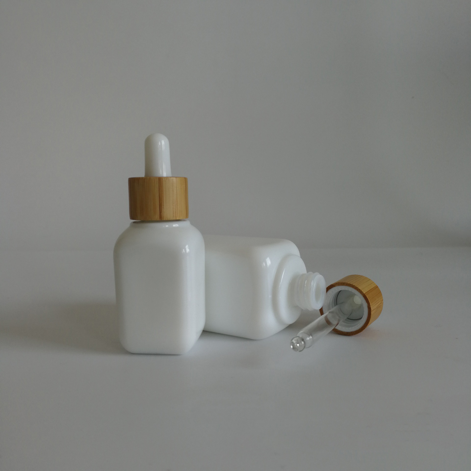 luxury cosmetic packaging 30ml 50ml white glass ceramic squared CBD serums essential oils dropper bottles with bamboo rubber top