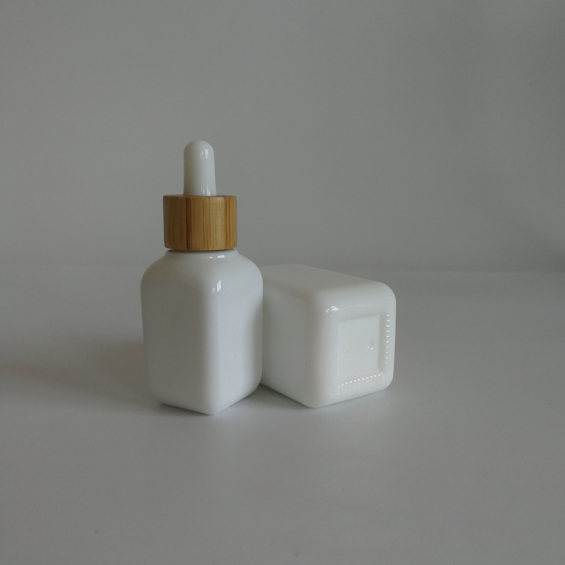 luxury cosmetic packaging 30ml 50ml white glass ceramic squared CBD serums essential oils dropper bottles with bamboo rubber top