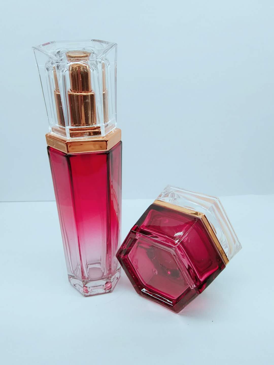luxury hexagon shaped gradient red color emulsion glass bottle set