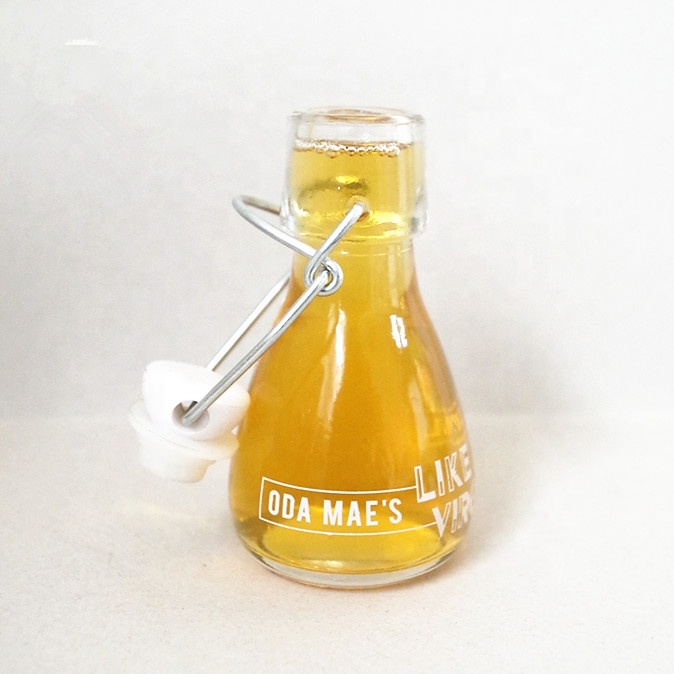 mini small  clear round clear beer glass bottle oil sauce cold pressed beverage juice wine use with airtight swing top