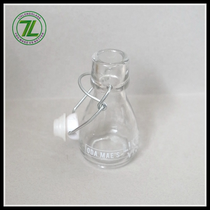 mini small clear round clear beer glass bottle oil sauce cold pressed beverage juice wine use with airtight swing top