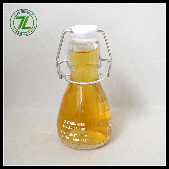 mini small clear round clear beer glass bottle oil sauce cold pressed beverage juice wine use with airtight swing top