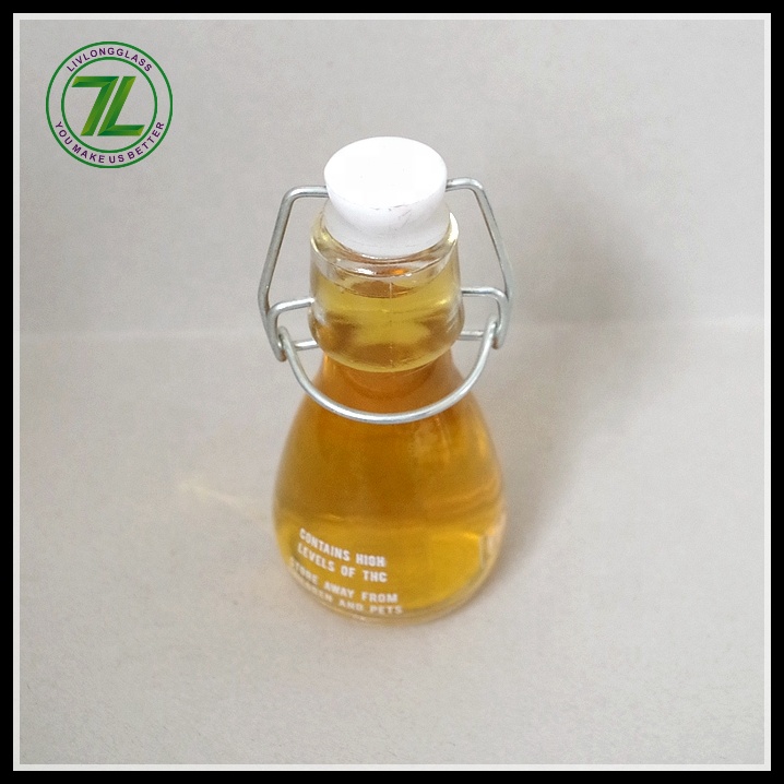 mini small clear round clear beer glass bottle oil sauce cold pressed beverage juice wine use with airtight swing top