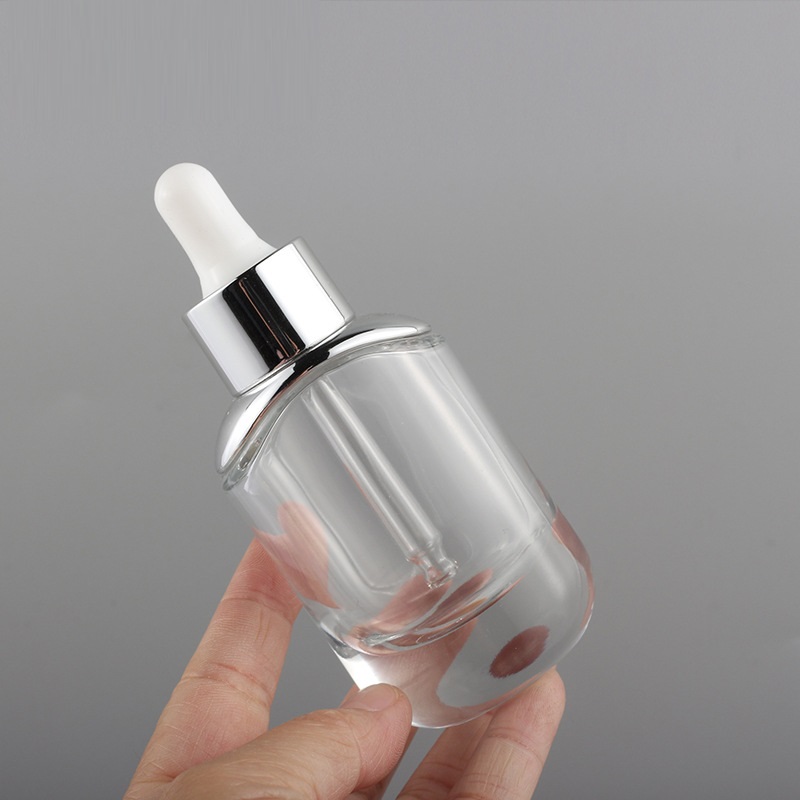 new oval shape 30ml thick bottom clear essential oil glass bottle 1 oz flat cosmetic serum bottles with silver gold dropper