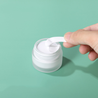popular shaped moisturiser round glass jar with white screw top lid