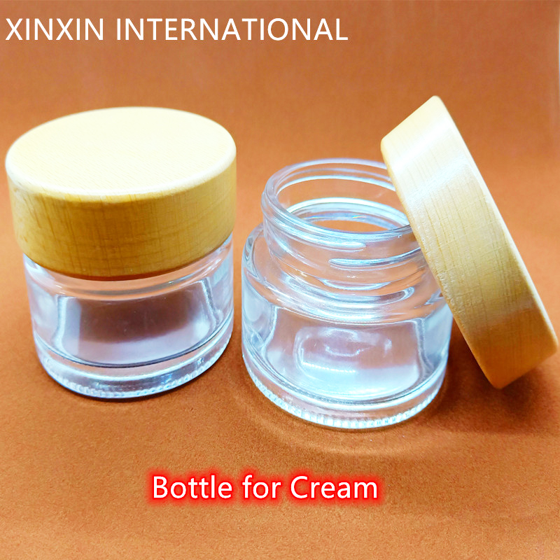 whole sale small clear and frosted 2 oz cosmetic cream glass jars for cream with wood lid and screw cap