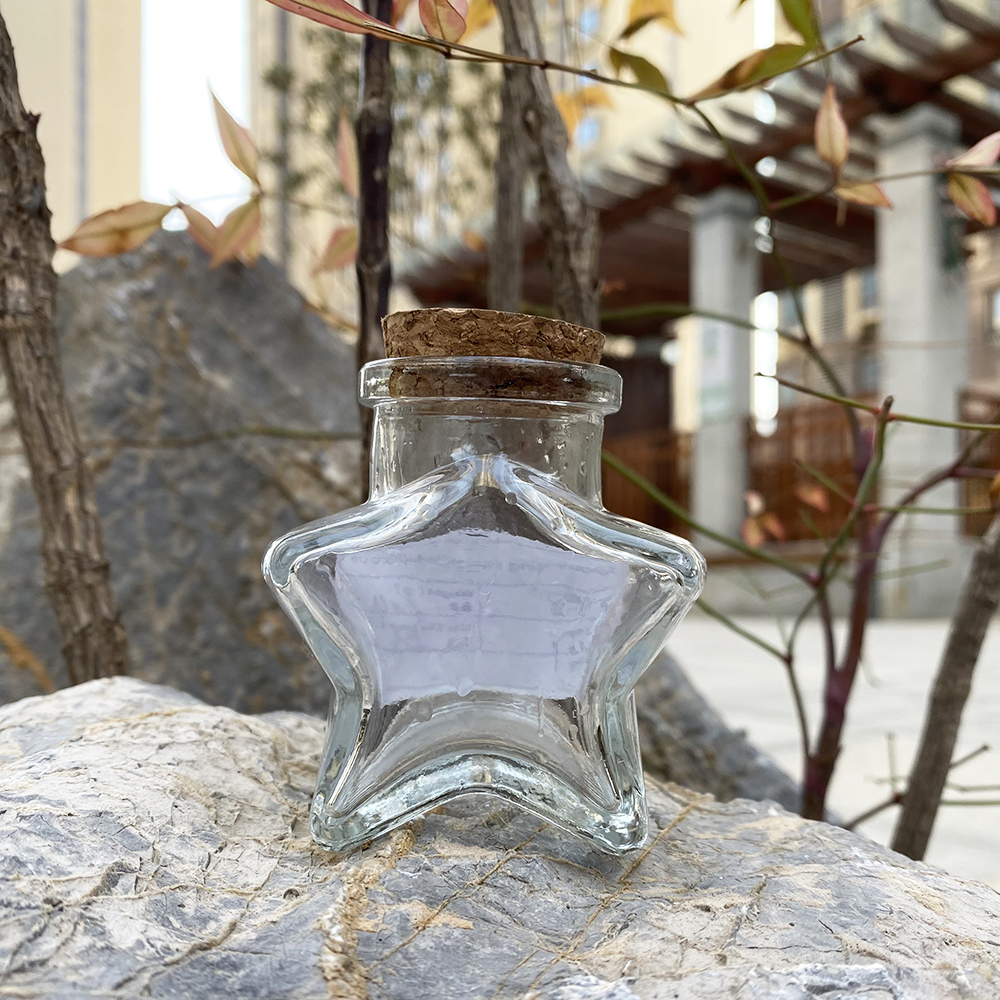 wholesale 50ml 150ml 300ml unique glass candy jars with lids lucky star wishing glass bottles with cork for wedding gift