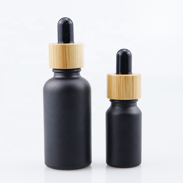 wholesale essential oil bottle glass dropper bottle with bamboo cap 10ml 30ml 60ml 100ml matt black tinture oil bottle