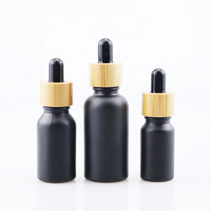 wholesale essential oil bottle glass dropper bottle with bamboo cap 10ml 30ml 60ml 100ml matt black tinture oil bottle