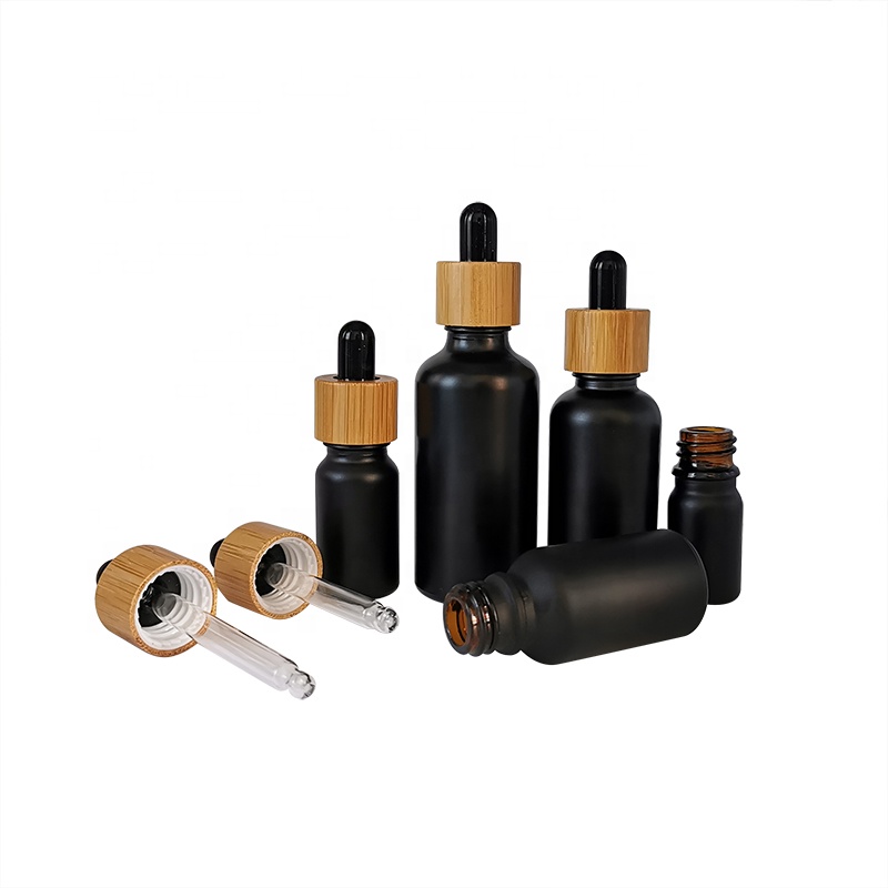 wholesale glass bottle cosmetic packaging 5ml 15ml 30ml 50ml black frosted essential oil glass bamboo dropper bottle
