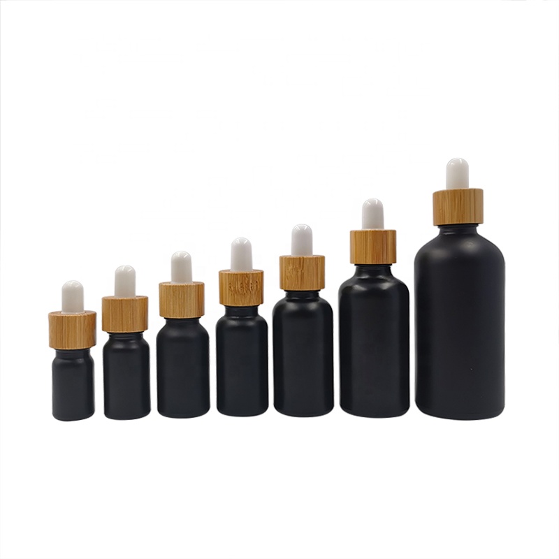 wholesale glass bottle cosmetic packaging 5ml 15ml 30ml 50ml black frosted essential oil glass bamboo dropper bottle