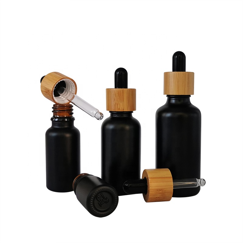 wholesale glass bottle cosmetic packaging 5ml 15ml 30ml 50ml black frosted essential oil glass bamboo dropper bottle