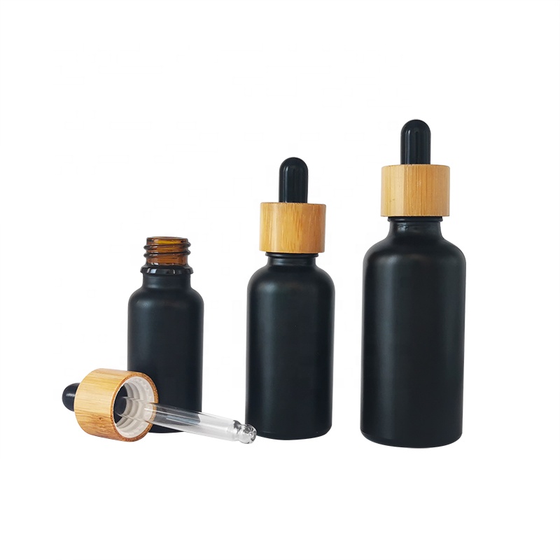wholesale glass bottle cosmetic packaging 5ml 15ml 30ml 50ml black frosted essential oil glass bamboo dropper bottle