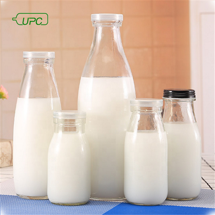 wholesale recycled empty clear glass milk juice beverage bollte with metal cap