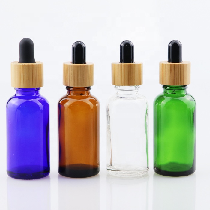 wooden bamboo cap essential oil glass bottle amber blue clear and green glass dropper 10ml 30 ml 60ml cosmetic body care bottle